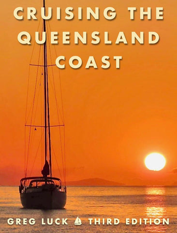 Book cover of 'Cruising the Queensland Coast' with a sailboat and sunset.